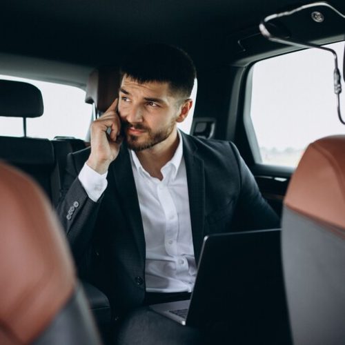 handsome-business-man-working-computer-car_1303-16420